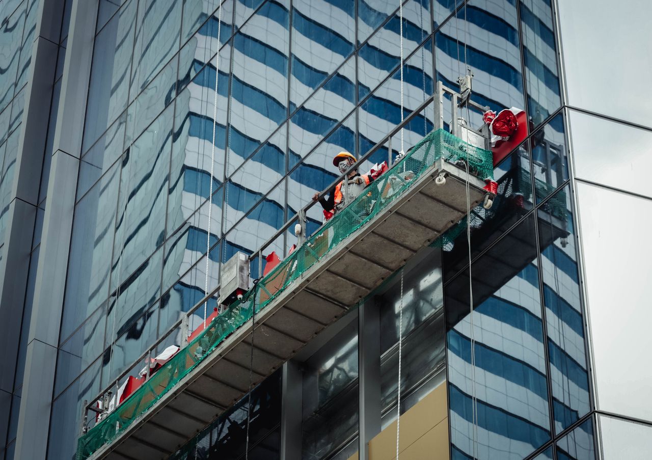 A city worker cleans the windows of a high-rise in Ho Chi Minh City, Vietnam.